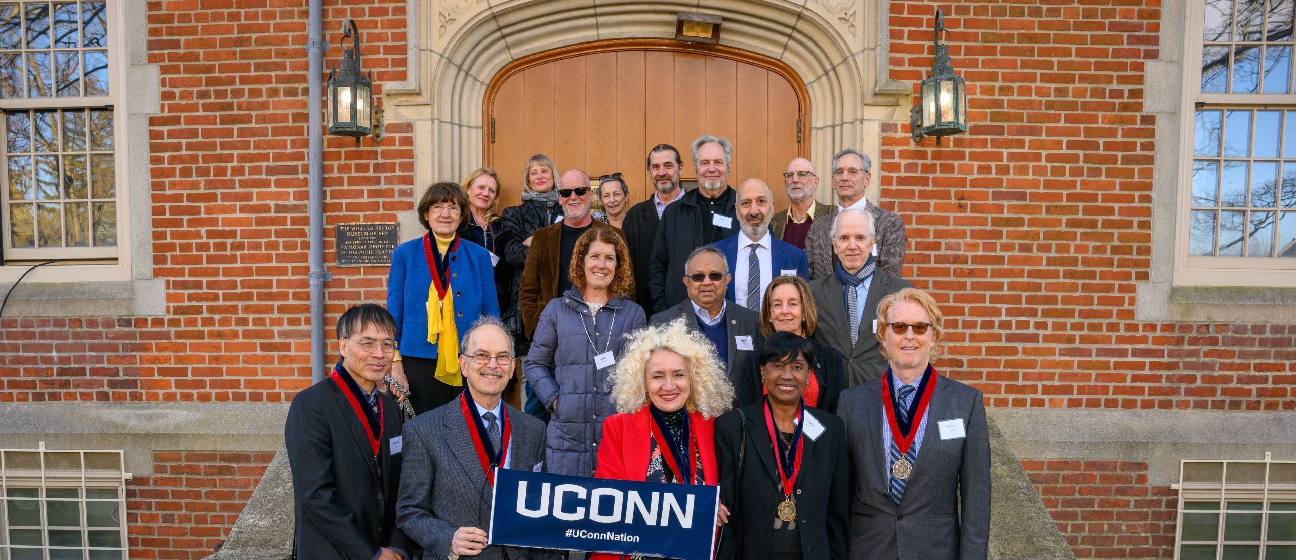 Current and past recipients of the Board of Trustees Distinguished Professor Award pose for a photo at the Benton Museum on April 5, 2022. (Peter Morenus/UConn Photo)
